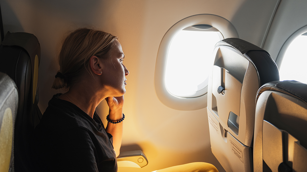 lady on plane looking out of window