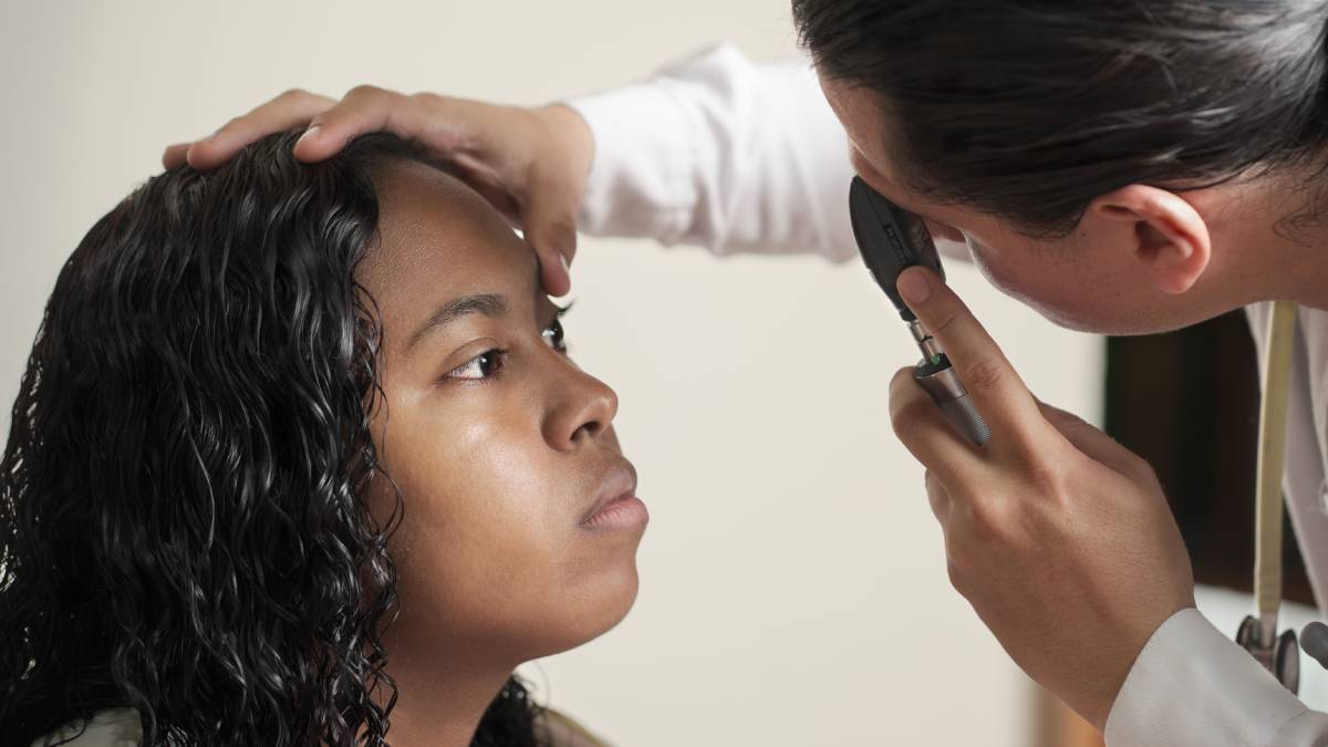 Doctor doing ophthalmoscopy