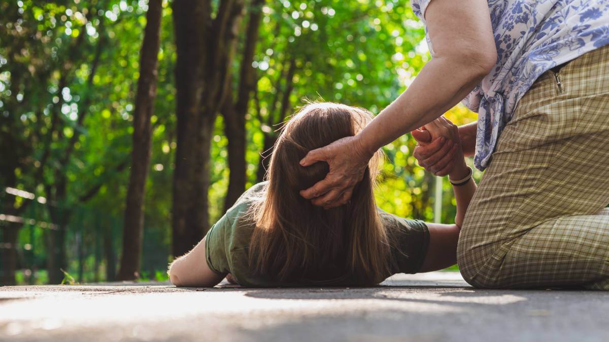 Woman being helped after fall