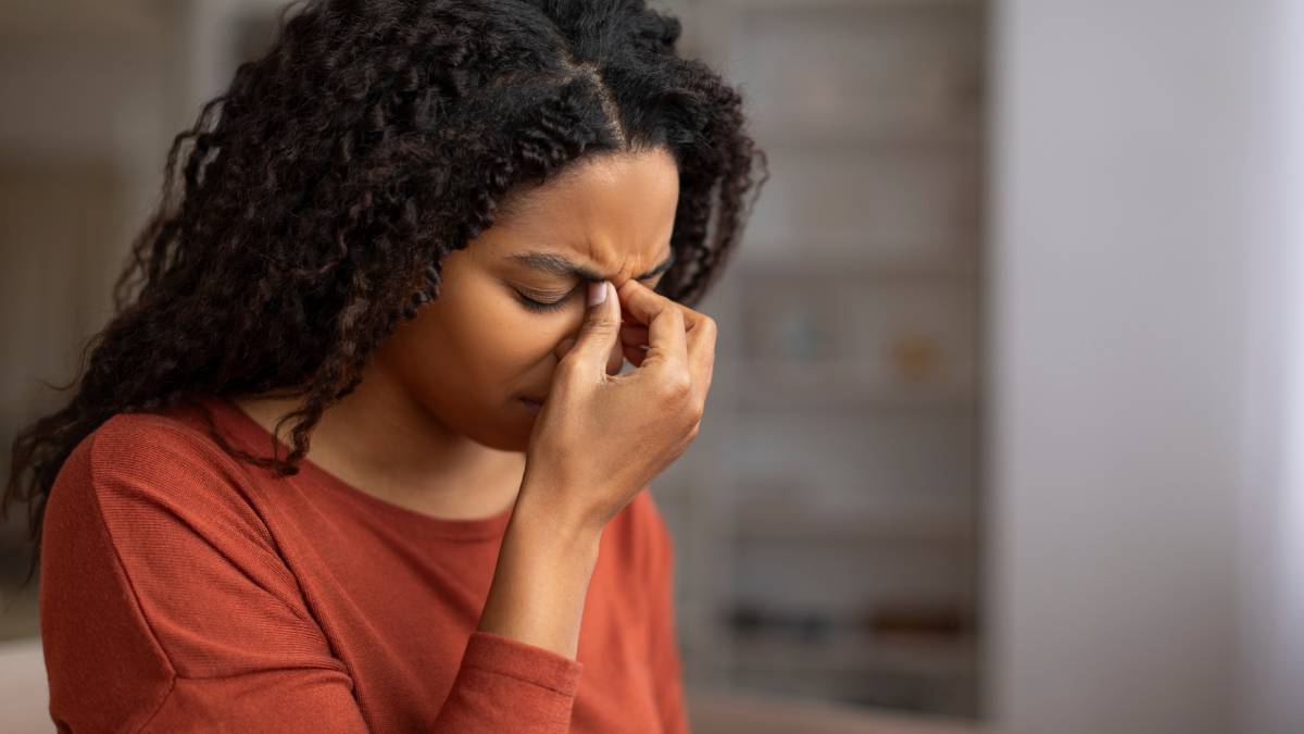 lady holding her head in pain